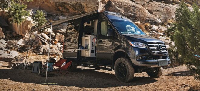 Sprinter Van with its side open, out in the camping spot.